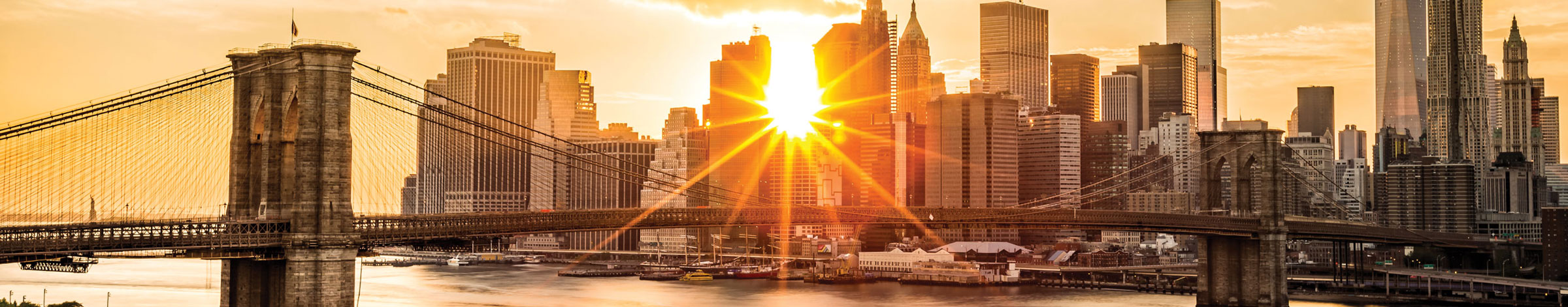 bridge leading into New York City at sunrise